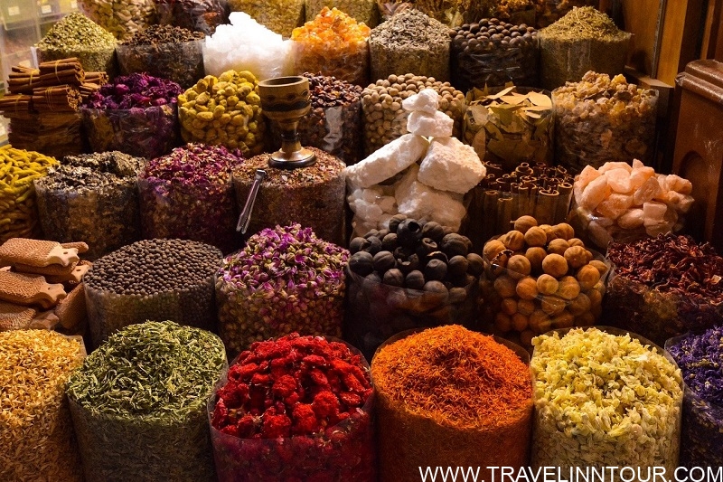 Dubai spice market with colorful spice bags and herbs on display, featuring vibrant yellows, reds, and browns, perfect for a 2 day Dubai itinerary.