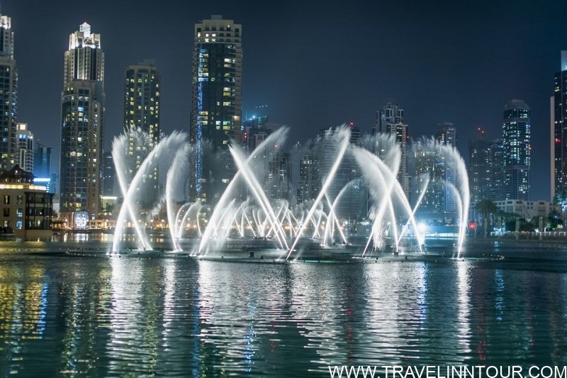 Dubai Fountain show at night with illuminated city skyline, part of a 2-day itinerary exploring top attractions in Dubai.