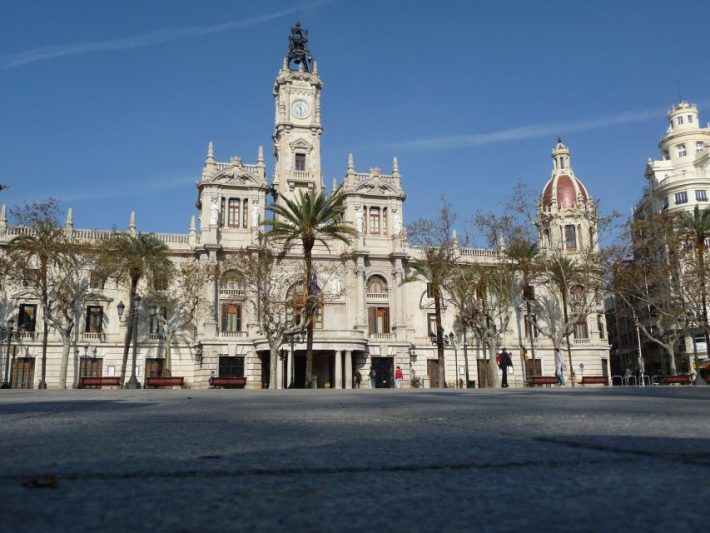 Valencia City Hall, a historic architectural landmark in Valencia, Spain, showcasing its grand facade and iconic clock tower under a clear blue sky.