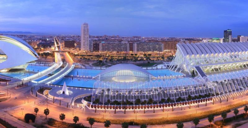 Panoramic view of Valencia's City of Arts and Sciences showcasing modern architecture against a twilight backdrop, highlighting key travel attractions.