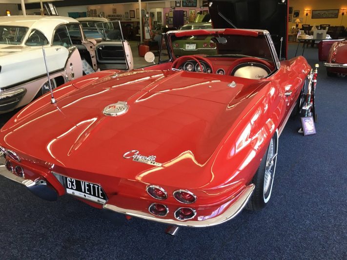 Red 1963 Corvette Convertible on display at a Texas car museum showcasing automotive history and classic cars.